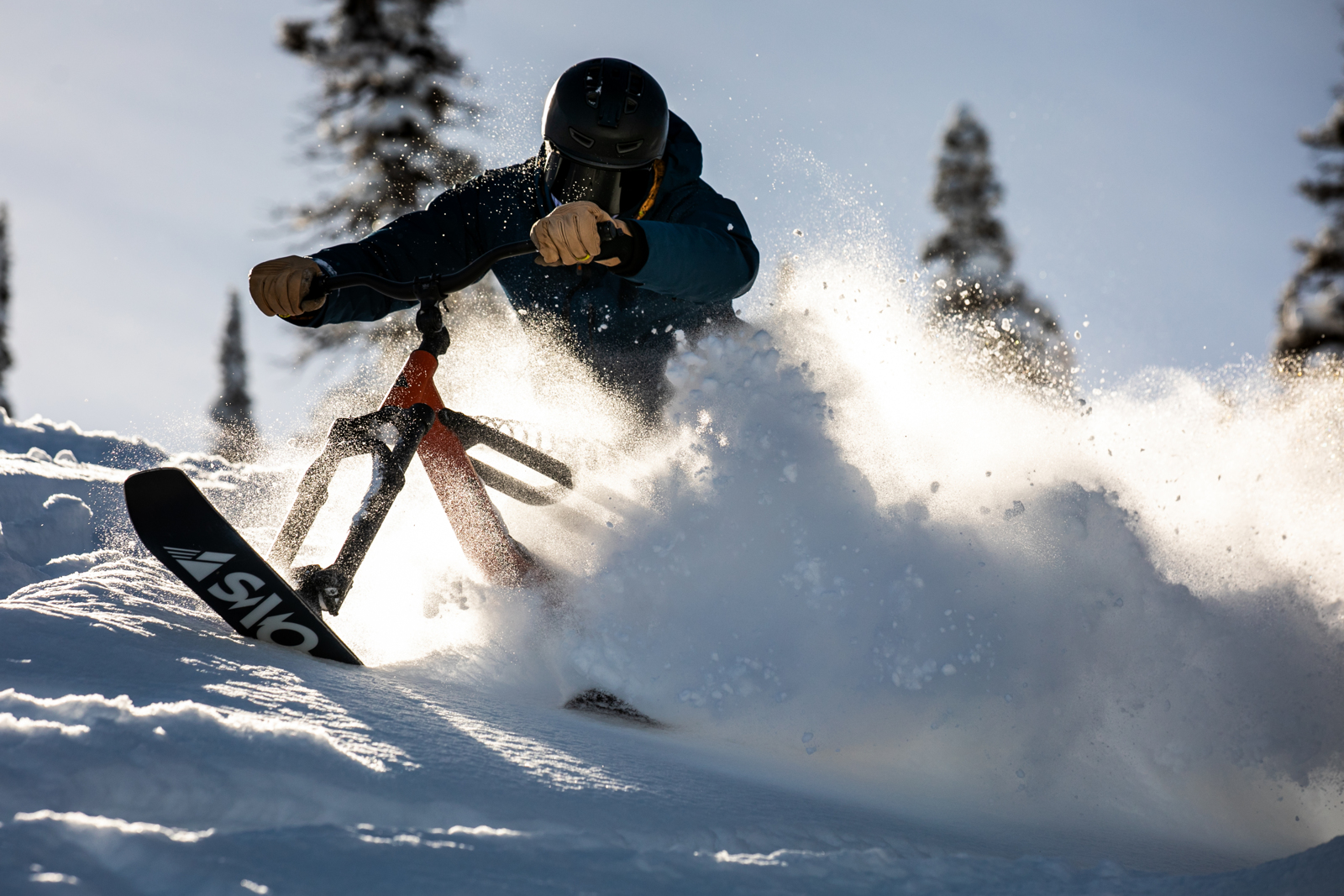 A person riding a bike in the snow